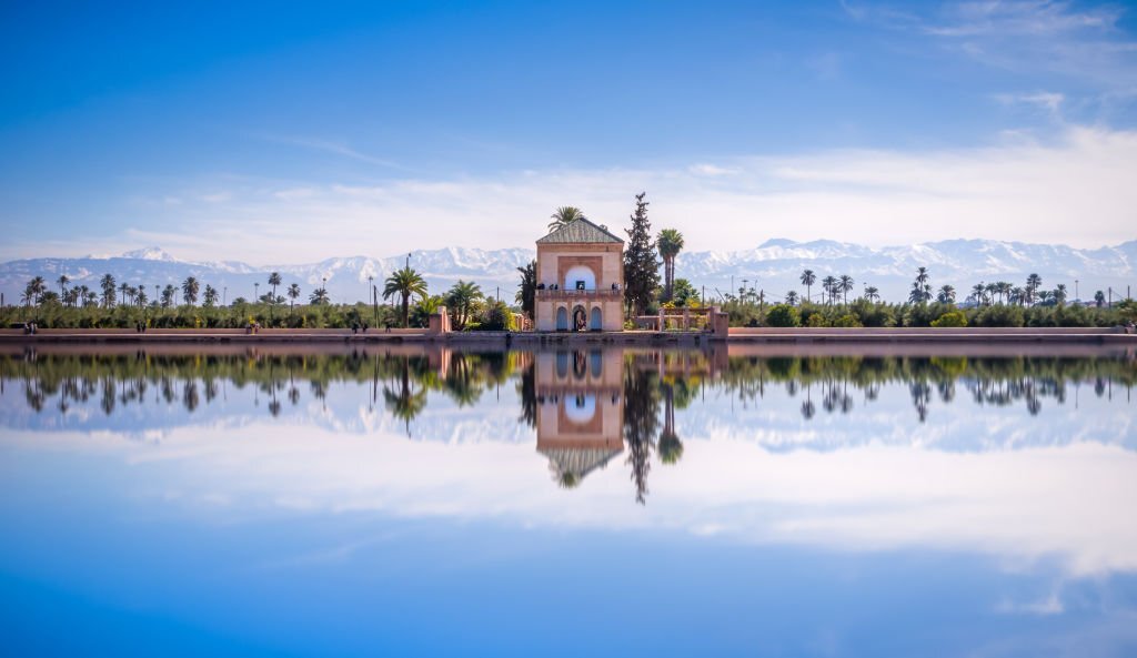 Panoramic view of Saadian pavilion, Menara gardens and Atlas mountains in Marrakech, Morocco, Africa